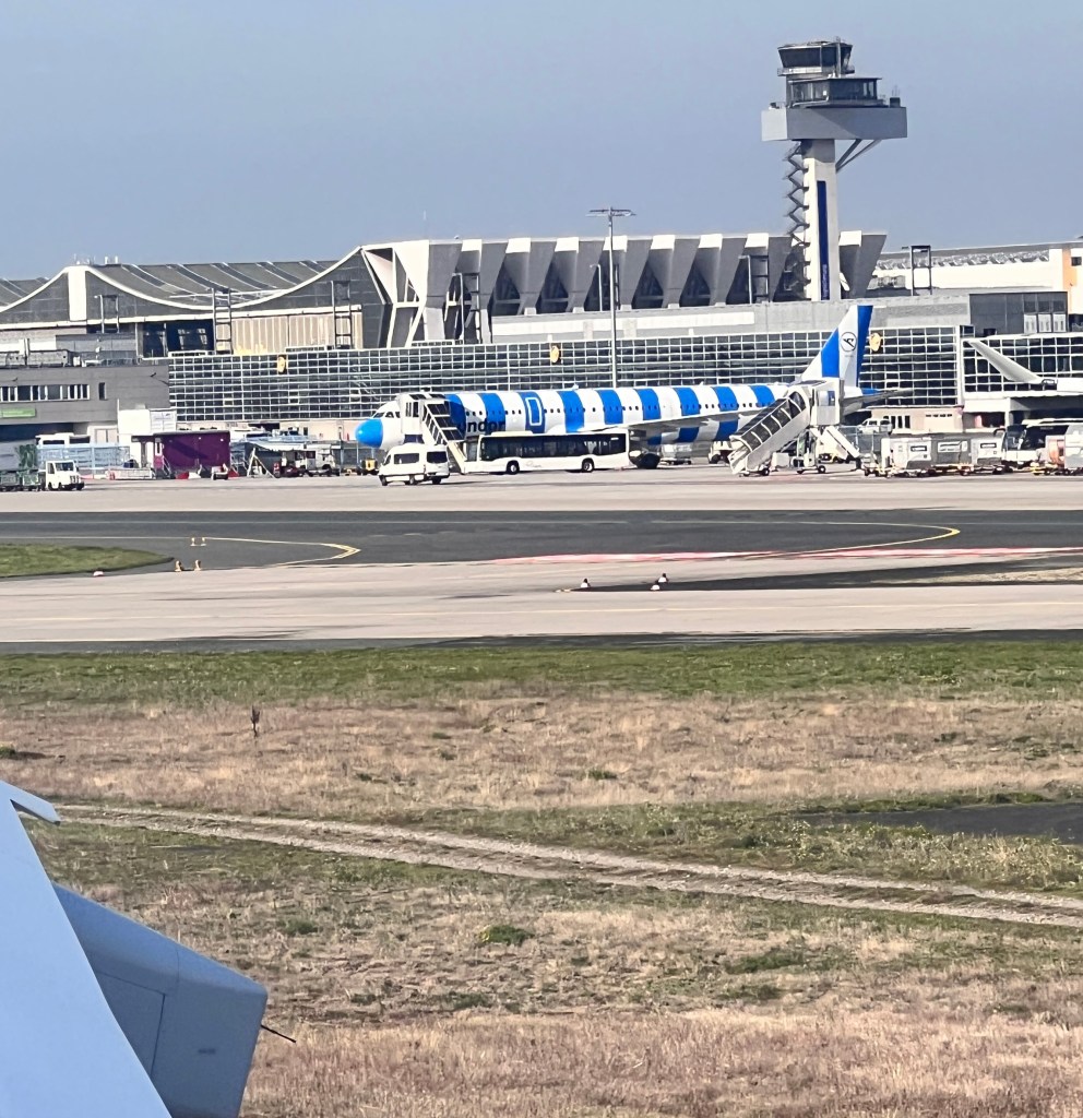 Photo of a Condor plane with new blue-and-white striped livery