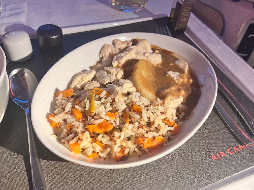 Main course service of chicken with rice and carrots in a maple-apple sauce.